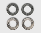 Four circular metallic ring-shaped  burr grinders arranged in a grid on a light gray background. Each ring has a textured spiral pattern and three small raised circular details near the edge.