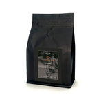 Black coffee bag with a label on a white background