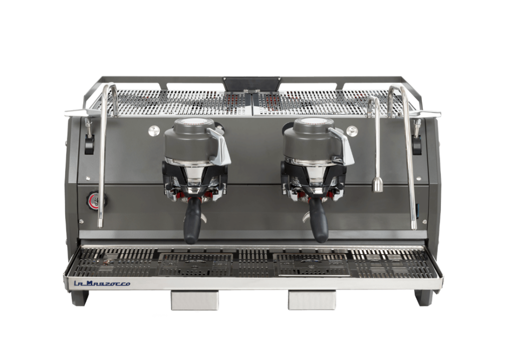 A professional double espresso machine by La Marzocco, featuring a dark gray metallic body, two integrated portafilter holders, a stainless steel drip tray, and a wire mesh upper rack, shown against a solid white background.