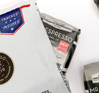 Coffee packages with visible branding on a white background